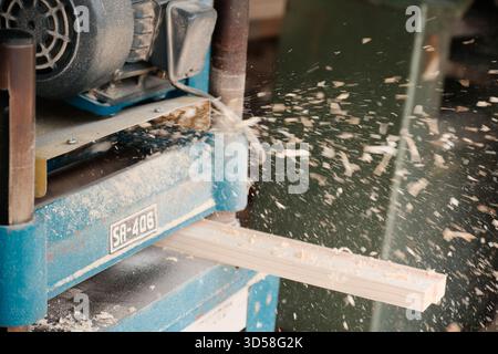 Wood Planer Shaping Timber with Flying Sawdust Stock Photo