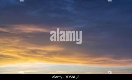 Glowing real sky at sunset texture background overlay. Dramatic red, orange, and purple clouds. High resolution photography perfect for sky replacement Stock Photo