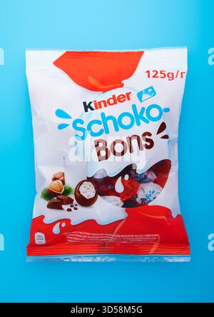 LONDON, UK - JANUARY 25, 2025: Pack of kinder schoko bons with cream and milk chocolate on blue. Stock Photo