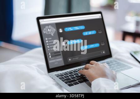Person using AI chatbot interface on laptop while relaxing at home, showing digital conversation, artificial intelligence technology, online communica Stock Photo