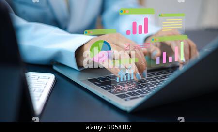Female professional working on laptop with digital analytics dashboard, business data charts, financial growth graphs and technology interface for mod Stock Photo