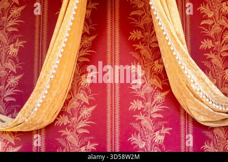 Elegant red and gold drapery with intricate floral patterns. Stock Photo