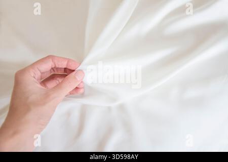 Female hand holding a soft white fabric Stock Photo