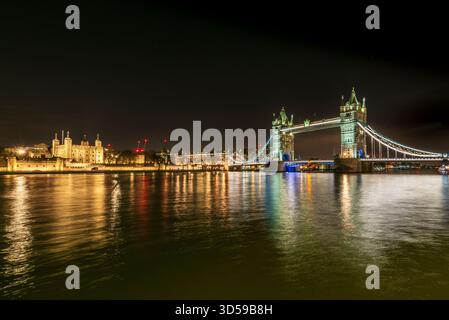 Night View of Tower Bridge and the Thames in London, Illuminated and Reflective Stock Photo