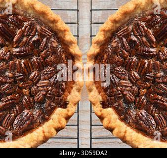 High angle view of two fresh baked holiday Pecan Pies on cooling racks atop a rustic wood kitchen table. Stock Photo