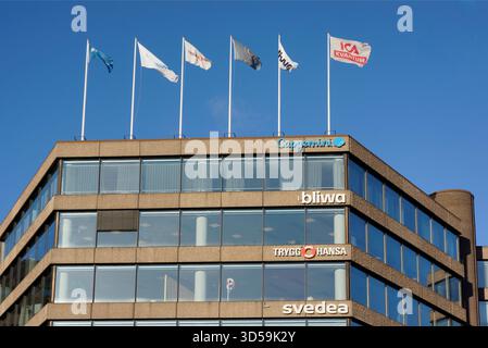 Stockholm, Sweden - November 14, 2025: Company logos on an office tower exterior in Stockholm. Stock Photo
