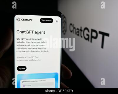 Stuttgart, Germany - 11-05-2025: Person holding smartphone with web page of generative AI chatbot ChatGPT (OpenAI) on screen in front of logo. Stock Photo