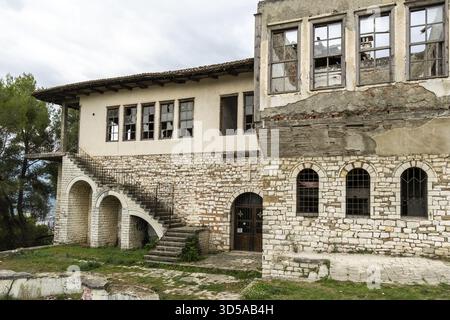 Ruined stone house with destroyed windows and stairs in the castle, Berat, Berat district, Albania Stock Photo