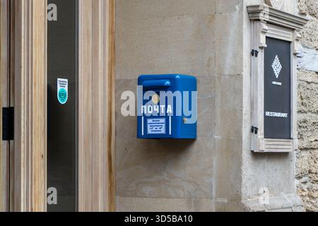 Azerbaijan, Baku. Ancient USSR Blue Classic Traditonal Postbox Outdoors. Blue public mailbox on a stone wall in what appears to be Baku, Azerbaijan. Stock Photo