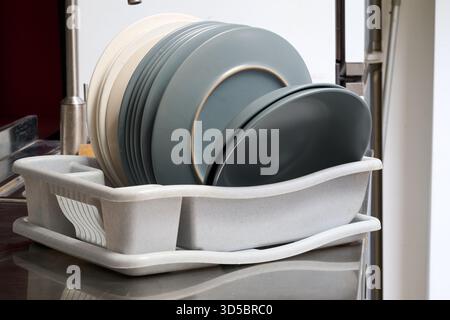 the dishes dry on the drying rack from front Stock Photo