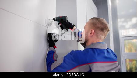 Professional Technician Installing CCTV Camera For Security Surveillance Video Service. Stock Photo