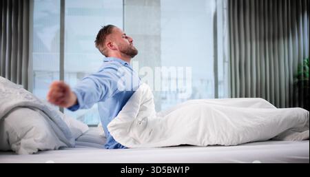 Happy Man Waking Up, Stretching Whole Body, Ready For Day. Stock Photo