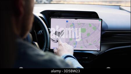 Young Male Engineer Designing Interactive Touch Screen Dashboard For Electric Car. Stock Photo