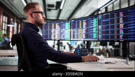 Young Male Billing Analyst Working On Medical Coding Spreadsheets Online. Stock Photo