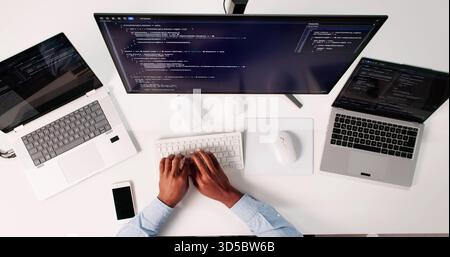 Top View Of African American Programmer Man Coding On Computer Stock Photo