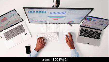 Man Analyzing Business Data On Top Screen In High Office. Stock Photo