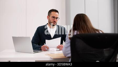 Employee Investigation: Female Employee Meeting Police For Disciplinary Interview Stock Photo