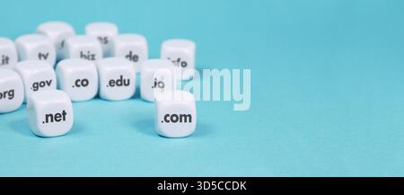 Internet domain names and website hosting dns concept with web domains sign and text on white dices . Website header and banner with copy space on cya Stock Photo