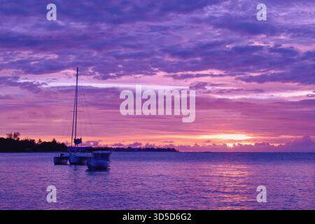 Yacht on the sea within a beautiful colorful sunset, Grand Baie, Mauritius Stock Photo