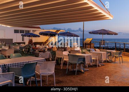 Restaurant at La Caleta de Adeje at dusk, Tenerife, Canary Islands Stock Photo