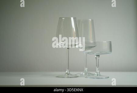 Three different glass goblets on the table. Glassware for alcoholic drinks. Barware. Stock Photo