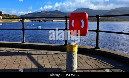 View from Barmouth looking over the Mawddach Estuary to the mountains of Cadair Idris and the Barmouth Viaduct/Bridge on a sunny day. Stock Photo