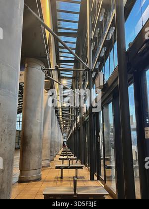 Contemporary architectural corridor with glass walls and structural columns in Hull, England. Clean lines, symmetry Stock Photo