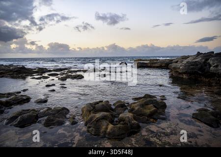 Seaside coast with volcanic rocks at sunset, La Santa, Lanzarote, Canary Islands, Spain Stock Photo