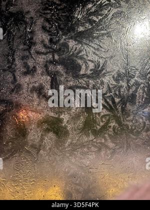 Abstract frost formations on a glass surface in Hull, England, creating natural icy patterns and textures during cold winter weather. Stock Photo