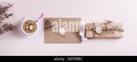Craft envelope with wax seal and crafting items on pink top view web banner Stock Photo
