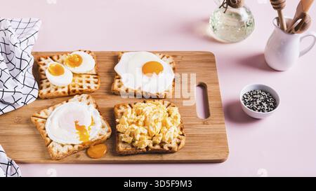 Scrambled egg, poached egg, fried egg, boiled egg on toast on a board web banner Stock Photo