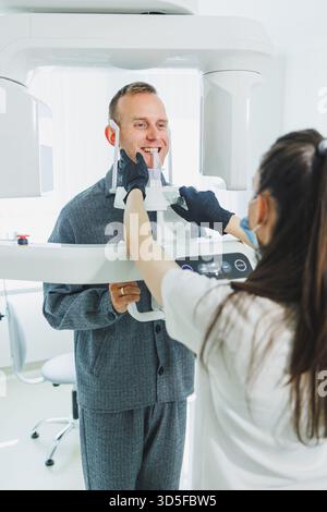 A young man underwent a CT scan of the jaw, a circular image of the jaw in modern dentistry. Radiology, panoramic scanner. Stock Photo
