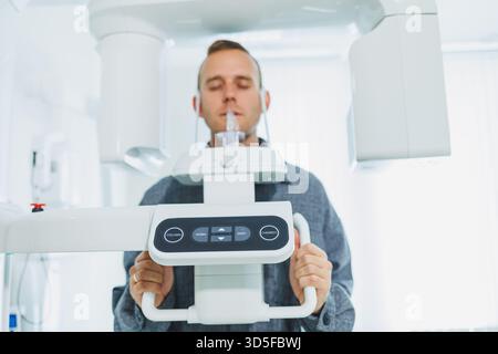 A young man underwent a CT scan of the jaw, a circular image of the jaw in modern dentistry. Radiology, panoramic scanner. Stock Photo