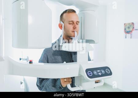 A young man underwent a CT scan of the jaw, a circular image of the jaw in modern dentistry. Radiology, panoramic scanner. Stock Photo