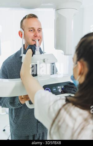 A young man underwent a CT scan of the jaw, a circular image of the jaw in modern dentistry. Radiology, panoramic scanner. Stock Photo