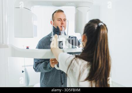 A young man underwent a CT scan of the jaw, a circular image of the jaw in modern dentistry. Radiology, panoramic scanner. Stock Photo
