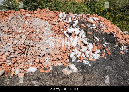 Heap of construction debris - broken pieces of bricks and concrete blocks Stock Photo