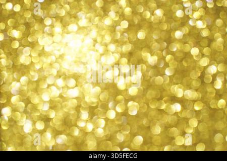 Bokeh circle with gold sparkles background. Yellow glitter backdrop. Golden texture. New year luxury snow. Copyspace. Shimmer confetti wallpaper. Drea Stock Photo