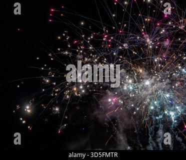 Bright colorful fireworks exploding in the night sky during a celebration or festive event Stock Photo