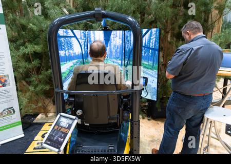 Berlin, Germany - January 22, 2024: Man is engaged with a virtual reality simulator showcasing a forest environment. Stock Photo