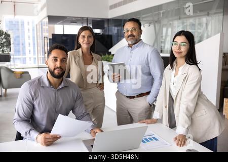 Diverse business team of four different aged professionals Stock Photo