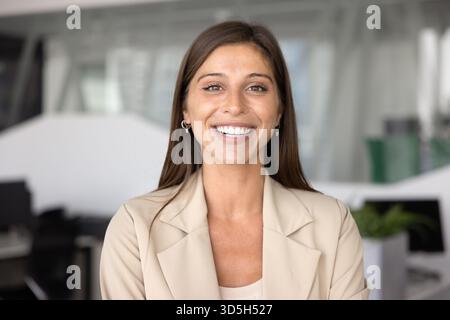Cheerful attractive Hispanic business professional woman posing for portrait Stock Photo