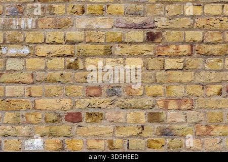 Background from a wall made of old beige bricks Stock Photo