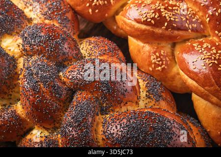 Shabbat Shalom. Bread challah with sesame seeds and poppy seeds on wooden background. Traditional jewish bread for Shabbat and Holidays. Rustic concept. Copy space. Selective focus. Stock Photo