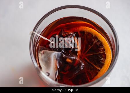 Overhead view of a glass cup with a mulled tea teabag and assorted spices Stock Photo