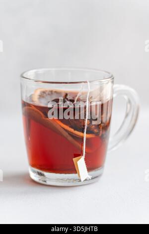 Close-up of a glass cup with a mulled tea teabag and assorted spices Stock Photo