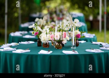 Elegant table settings with assorted floral arrangements ready for a garden party Stock Photo