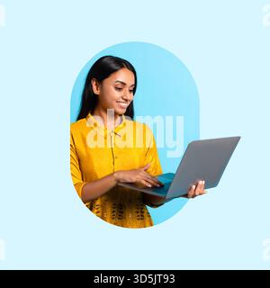 Smiling Woman Using Laptop in Bright Blue Setting While Wearing a Yellow Shirt Stock Photo