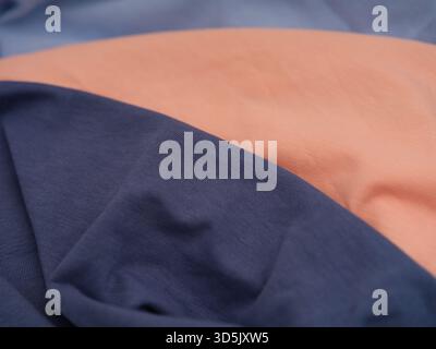 Close-up of three soft cotton fabric textures in dark blue, pink and blue colours. Stock Photo