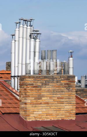 Exhaust pipes and chimneys on an apartment building Stock Photo